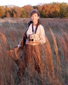 Carol Clark in a field of tall grasses