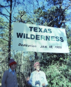 two men in front of Texas Wilderness dedication January 18, 1985 sign